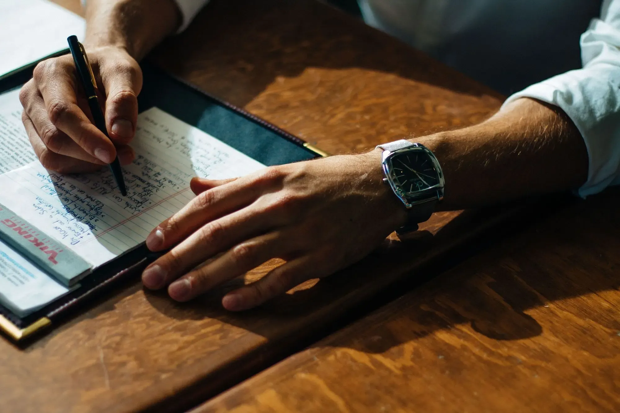 A person take notes during a remote interview