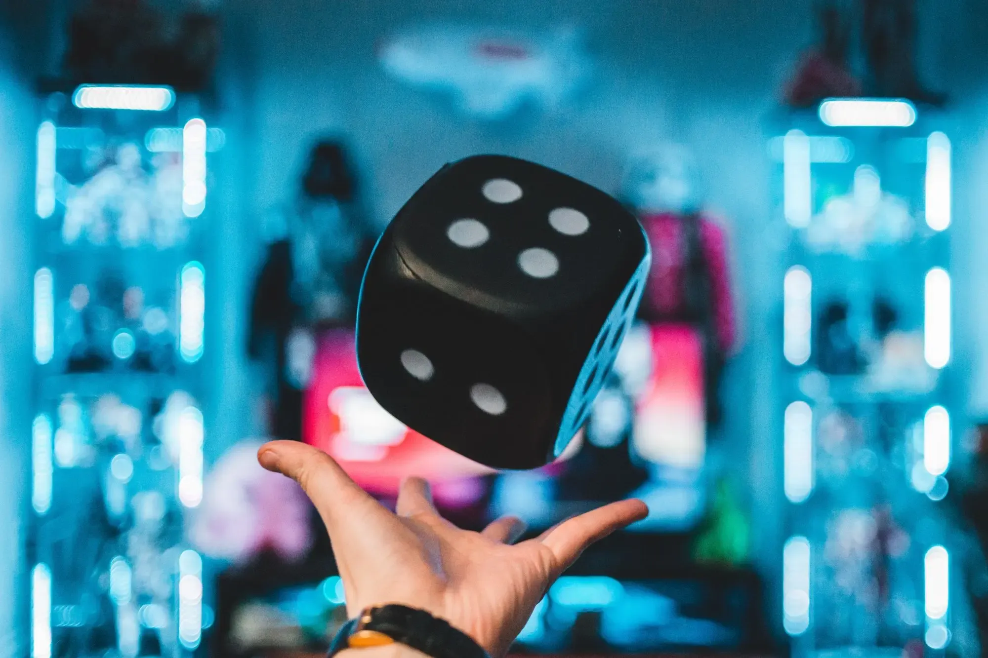 A person's hand and a large dice