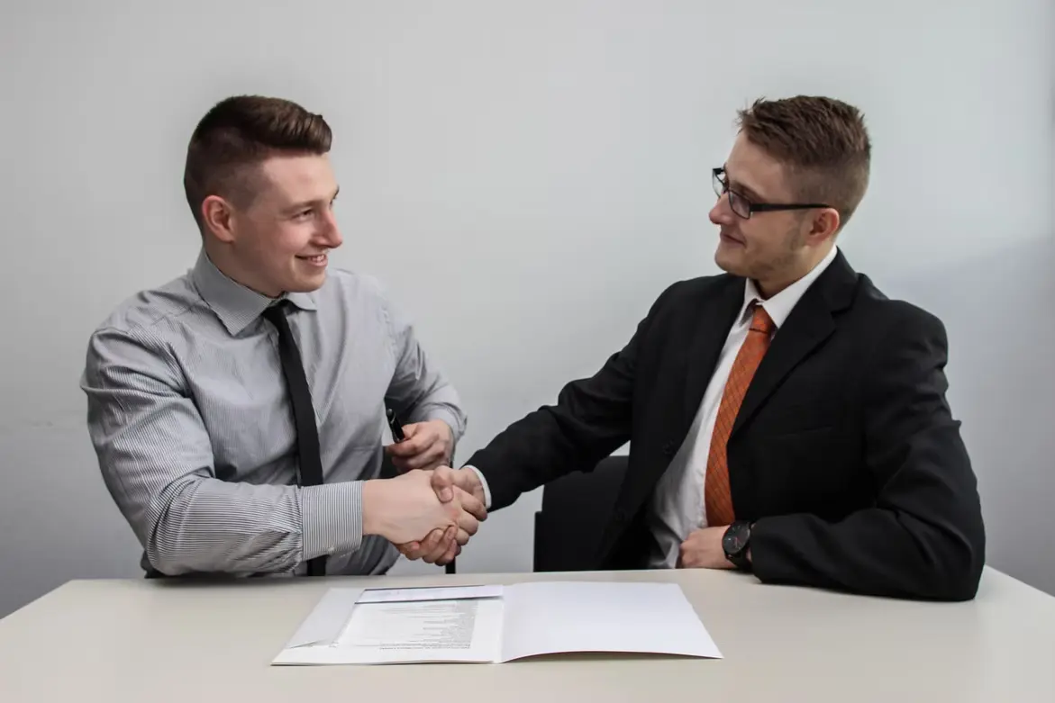 two men at work shaking hands