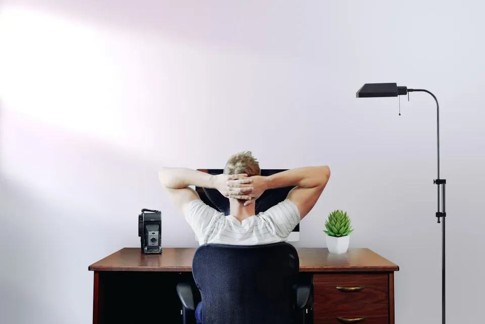 A remote employee sitting before his computer